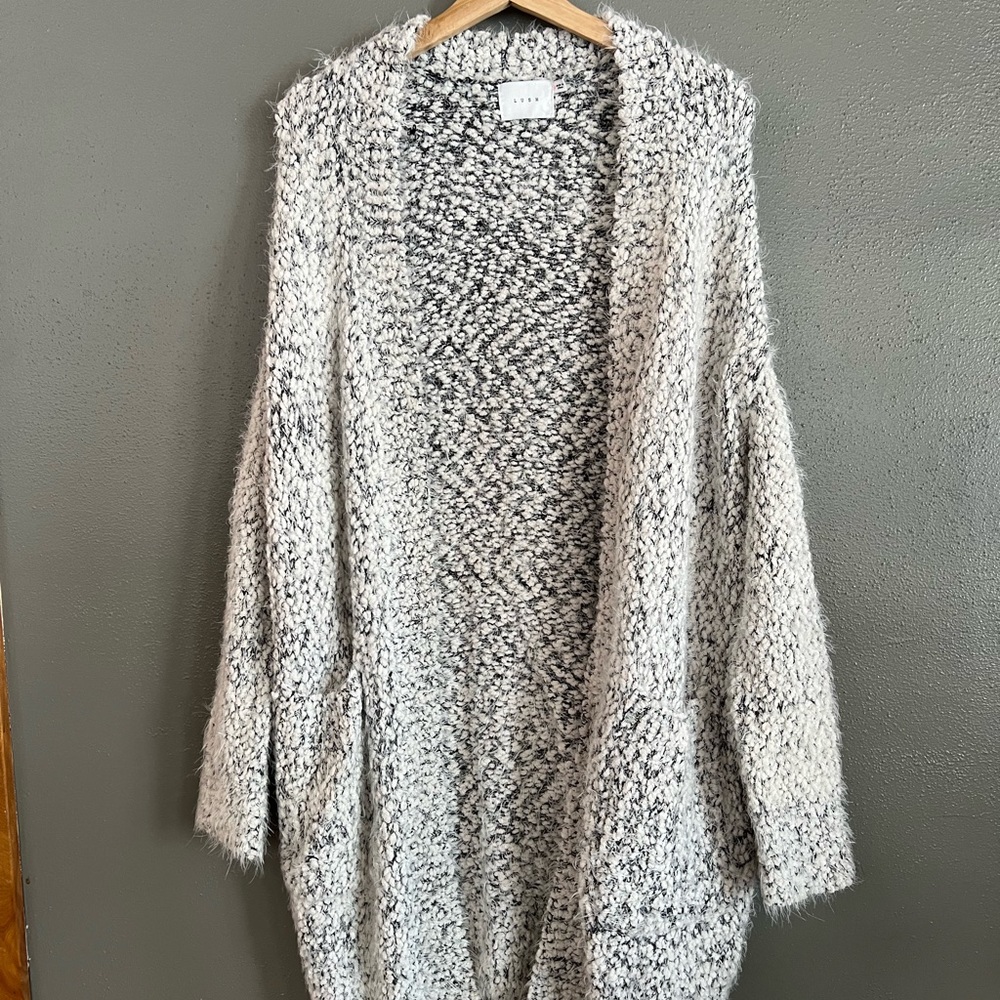 Oversized fuzzy black and white knee length sweater in size small.